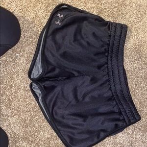 Black UNDER-ARMOR workout shorts.